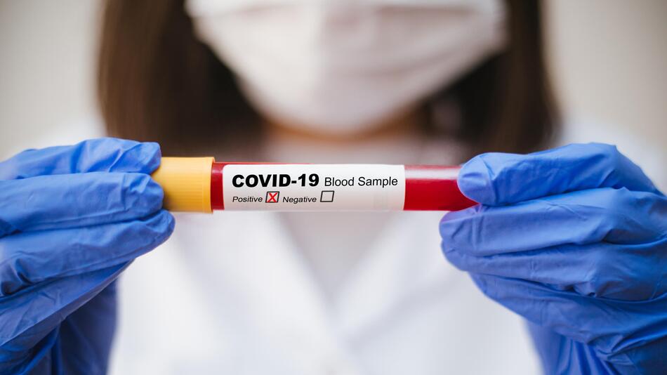 Holding test tube with COVID-19