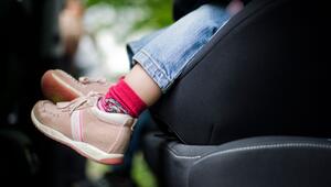 Mädchen sitzt in einem Kindersitz im Auto