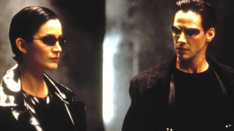 Schwarze Leder-Outfits und Sonnenbrillen: Carrie-Anne Moss und Keanu Reeves in "Matrix".