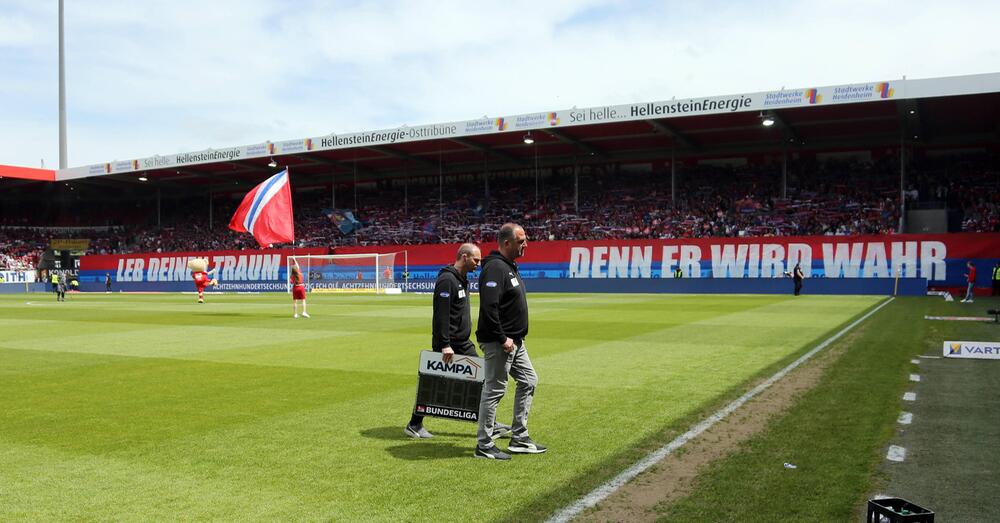 Frank Schmidt läuft an einer Choreographie des 1. FC Heidenheim vorbei.