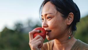 Frau, die in Apfel beißt. 