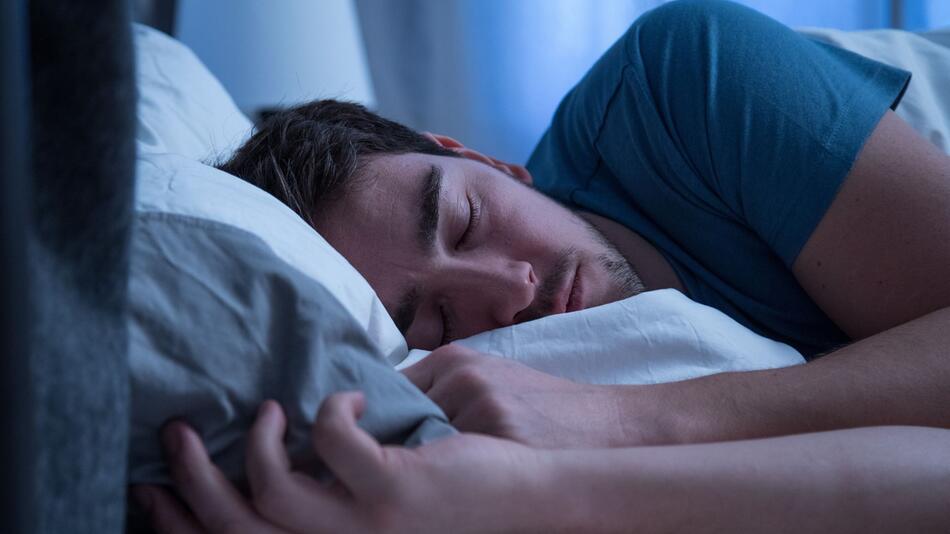 Mann schläft in einem Bett